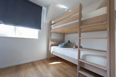 Ein Bett oder Betten in einem Zimmer der Unterkunft Ferienreihenhaus Lale Andersen 4a
