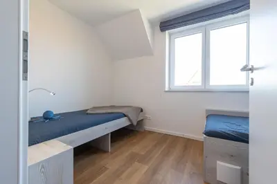 Ein Bett oder Betten in einem Zimmer der Unterkunft Ferienreihenhaus 