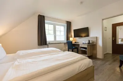 Ein Bett oder Betten in einem Zimmer der Unterkunft Cuxlandhotel Doppelzimmer 116