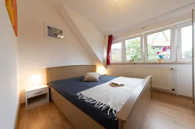 Ein Bett oder Betten in einem Zimmer der Unterkunft Ferienwohnung Sieltrift 4-08