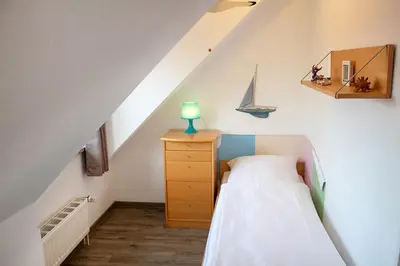 Ein Bett oder Betten in einem Zimmer der Unterkunft Ferienwohnung Sieltrift 4-12