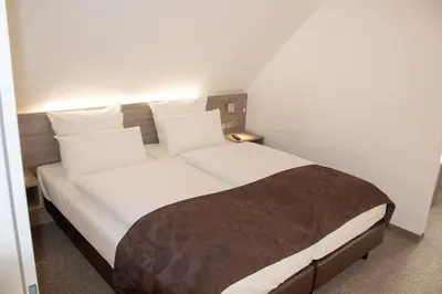 Ein Bett oder Betten in einem Zimmer der Unterkunft Cuxlandhotel Studio 202