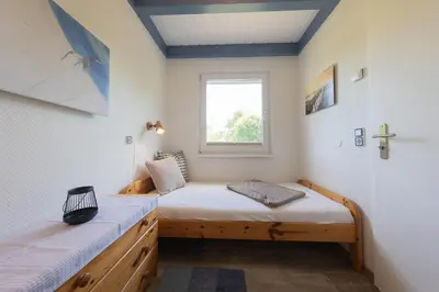 Ein Bett oder Betten in einem Zimmer der Unterkunft Ferienhaus Knechtsand 09