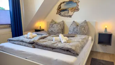 Ein Bett oder Betten in einem Zimmer der Unterkunft Meerblick Apartment Nordseeperle 11