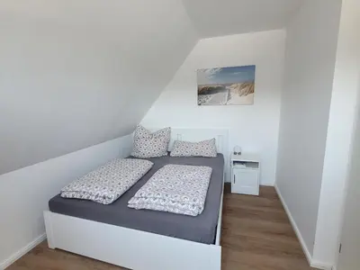 Ein Bett oder Betten in einem Zimmer der Unterkunft Residenz Strandhaus Döse