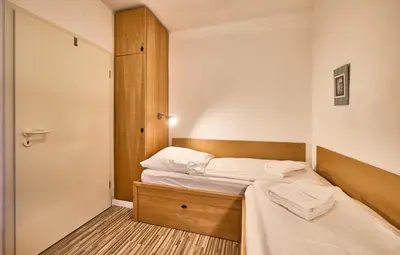 Ein Bett oder Betten in einem Zimmer der Unterkunft Anlage Am Wehrberg - Wohnung Eule