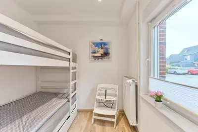 Ein Bett oder Betten in einem Zimmer der Unterkunft Direkt an der Perlebucht - Wattn' Glück by Nordic Homes