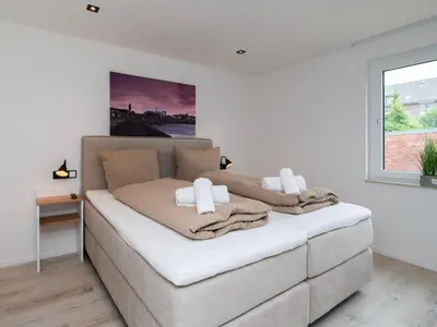 Ein Bett oder Betten in einem Zimmer der Unterkunft Inseltörn Wohnung 3