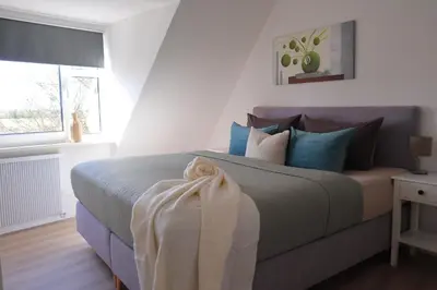 Ein Bett oder Betten in einem Zimmer der Unterkunft Ferienhaus Nordlicht