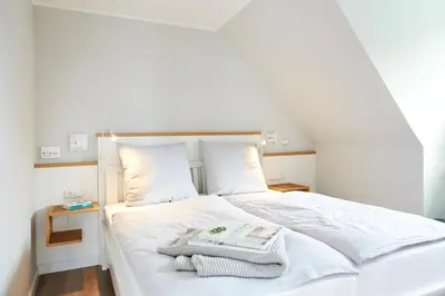 Ein Bett oder Betten in einem Zimmer der Unterkunft Dat-Meerhus Wohnung 4