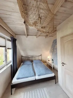 Ein Bett oder Betten in einem Zimmer der Unterkunft Ferienhaus ROSA mit Sauna