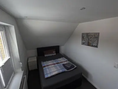 Ein Bett oder Betten in einem Zimmer der Unterkunft Ferienwohnung in Brunsbüttel mit E-Bike Verleih