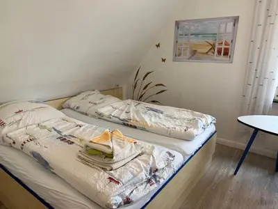 Ein Bett oder Betten in einem Zimmer der Unterkunft Haus Meereswoge