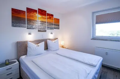Ein Bett oder Betten in einem Zimmer der Unterkunft Strandhochhaus SA05