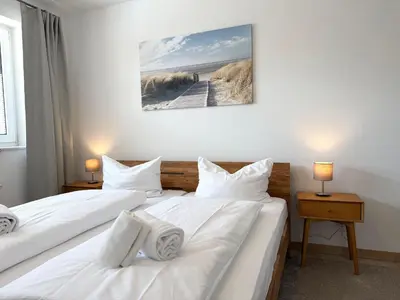 Ein Bett oder Betten in einem Zimmer der Unterkunft Haus am Waldbad FeWo 2