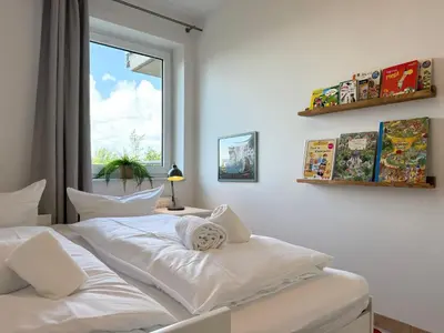 Ein Bett oder Betten in einem Zimmer der Unterkunft Haus am Waldbad FeWo 2