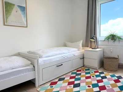 Ein Bett oder Betten in einem Zimmer der Unterkunft Haus am Waldbad FeWo 2