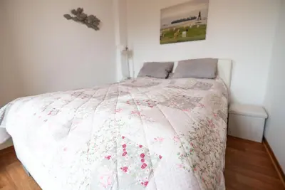 Ein Bett oder Betten in einem Zimmer der Unterkunft Haus Kehrwieder Wohnung Südsee
