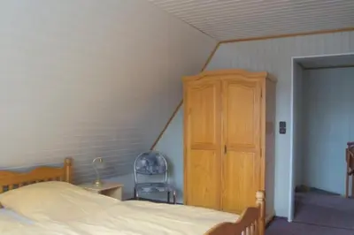Ein Bett oder Betten in einem Zimmer der Unterkunft 4 Personen Ferienhaus in zweiter Reihe zum Deich in Otterndorf