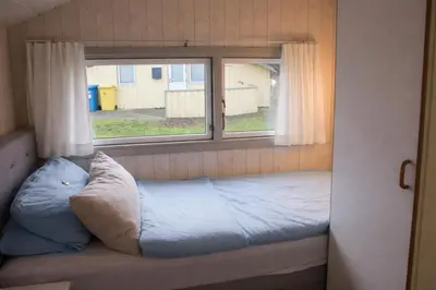 Ein Bett oder Betten in einem Zimmer der Unterkunft 5 Personen Ferienhaus mit Sauna, Kanu und herrlichem Seeblick in Otterndorf