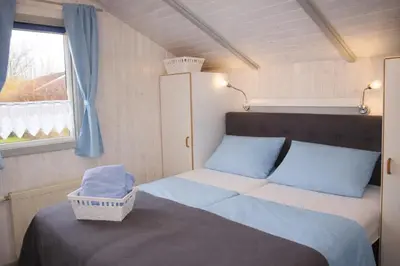 Ein Bett oder Betten in einem Zimmer der Unterkunft 5 Personen Ferienhaus mit Sauna, Kanu und herrlichem Seeblick in Otterndorf