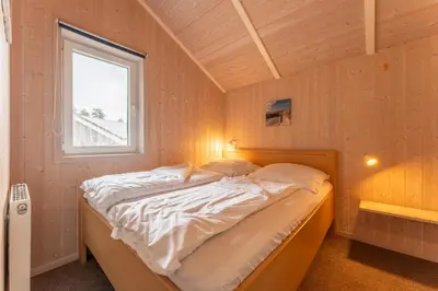 Ein Bett oder Betten in einem Zimmer der Unterkunft 6 Personen Ferienhaus in direkter Seelage mit Bootsteg und Kanu sowie Sauna, Whirlpool und Kaminofen in Otterndorf