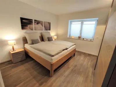 Ein Bett oder Betten in einem Zimmer der Unterkunft Whg Herzenszeit