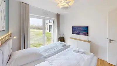 Ein Bett oder Betten in einem Zimmer der Unterkunft Lighthouse Duhner Spitze - W01
