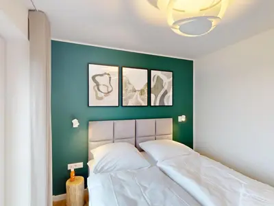 Ein Bett oder Betten in einem Zimmer der Unterkunft Lighthouse Duhner Spitze - W09