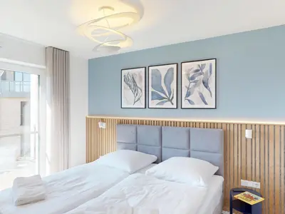 Ein Bett oder Betten in einem Zimmer der Unterkunft Lighthouse Duhner Spitze - W07