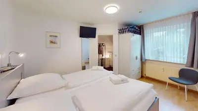 Ein Bett oder Betten in einem Zimmer der Unterkunft Stranddüne - 5