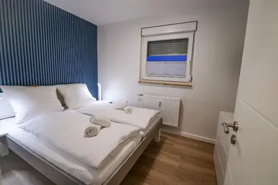 Ein Bett oder Betten in einem Zimmer der Unterkunft Strandhochhaus SF01