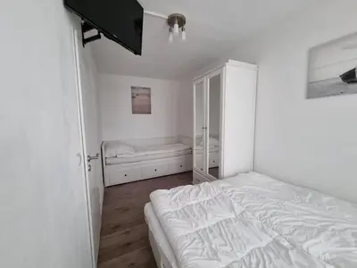 Ein Bett oder Betten in einem Zimmer der Unterkunft Frische Brise FeWo 02 09