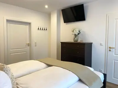 Ein Bett oder Betten in einem Zimmer der Unterkunft Haus Nordseebrandung FeWo 4