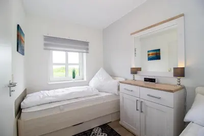 Ein Bett oder Betten in einem Zimmer der Unterkunft Deichgraf 345