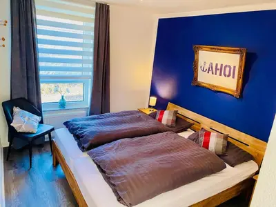 Ein Bett oder Betten in einem Zimmer der Unterkunft Lüttje Deichvilla XL