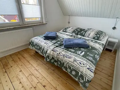 Ein Bett oder Betten in einem Zimmer der Unterkunft Nordsee Ferienhaus Gezeiten