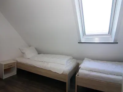 Ein Bett oder Betten in einem Zimmer der Unterkunft Ferienwohnung im Reihenhaus, Friedrichskoog-Spitze