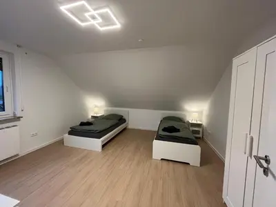 Ein Bett oder Betten in einem Zimmer der Unterkunft HörnQuartier - modern eingerichtete Ferienwohnung - Familienfreundlich, ideal auch für Geschäftskunden