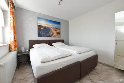 Ein Bett oder Betten in einem Zimmer der Unterkunft Hanseatic FeWo 812