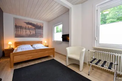 Ein Bett oder Betten in einem Zimmer der Unterkunft Strandkorb 12 - FeWo 1