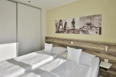 Ein Bett oder Betten in einem Zimmer der Unterkunft Duhner Strandhus, S14