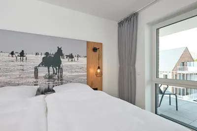 Ein Bett oder Betten in einem Zimmer der Unterkunft Nordstrand, N301