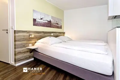 Ein Bett oder Betten in einem Zimmer der Unterkunft Duhner Strandhus, S12