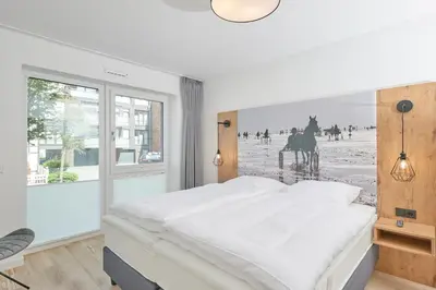 Ein Bett oder Betten in einem Zimmer der Unterkunft Nordstrand, N103