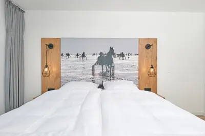 Ein Bett oder Betten in einem Zimmer der Unterkunft Nordstrand, N103