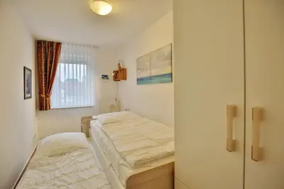 Ein Bett oder Betten in einem Zimmer der Unterkunft Duhner Brise, DB7