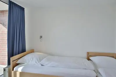 Ein Bett oder Betten in einem Zimmer der Unterkunft Hohe Worth, H304