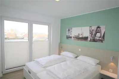 Ein Bett oder Betten in einem Zimmer der Unterkunft Duhner Brandung, B9