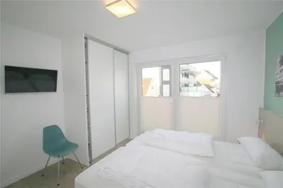 Ein Bett oder Betten in einem Zimmer der Unterkunft Duhner Brandung, B9